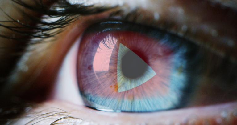 closeup of staring eye with Youtube logo reflecting over the pupil.