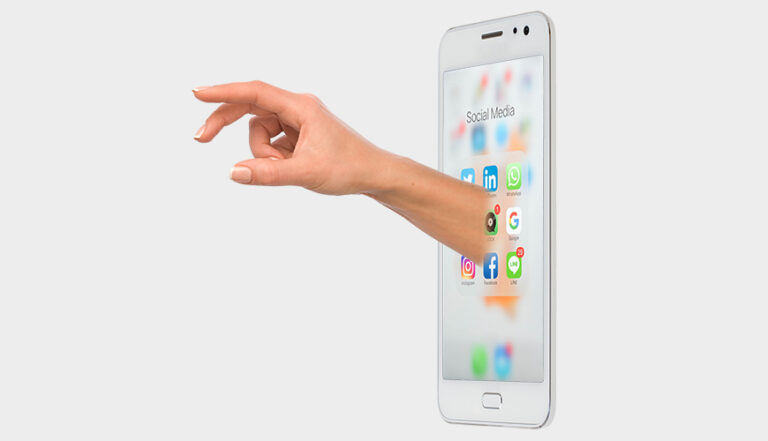 Hand reaching out of smartphone displaying social media icons