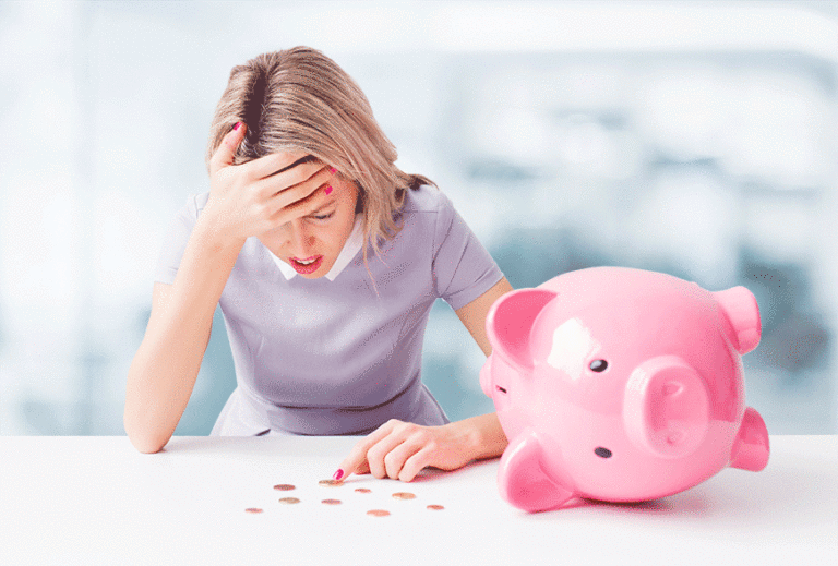Upset woman counting coins from a piggy bank