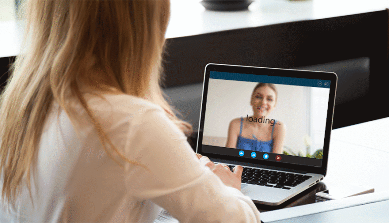 Two Gen Z women video chatting on laptop