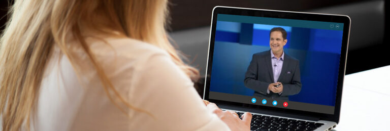 Woman with laptop watching Jason Dorsey deliver a speech at a virtual event